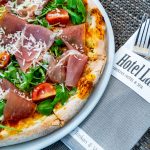 A pizza with cutlery.