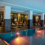 Latini_Pool_3 A room with a swimming pool and sun loungers.